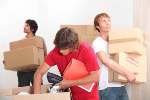 Professional moving team loading a truck in an urban Chelsea setting